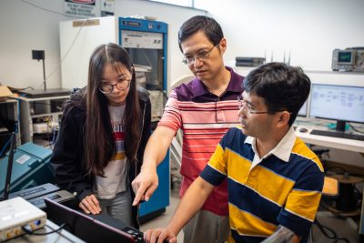 Lingjia Liu with students in the lab.