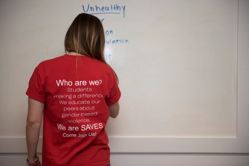 This shows a student in the SAVES program, wearing a shirt with the program's message on it.
